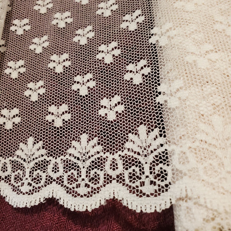 Flat lace 6in wide off white daisy design one scalloped edge