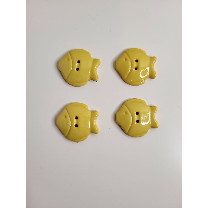 Yellow plastic fish buttons, set of 4.